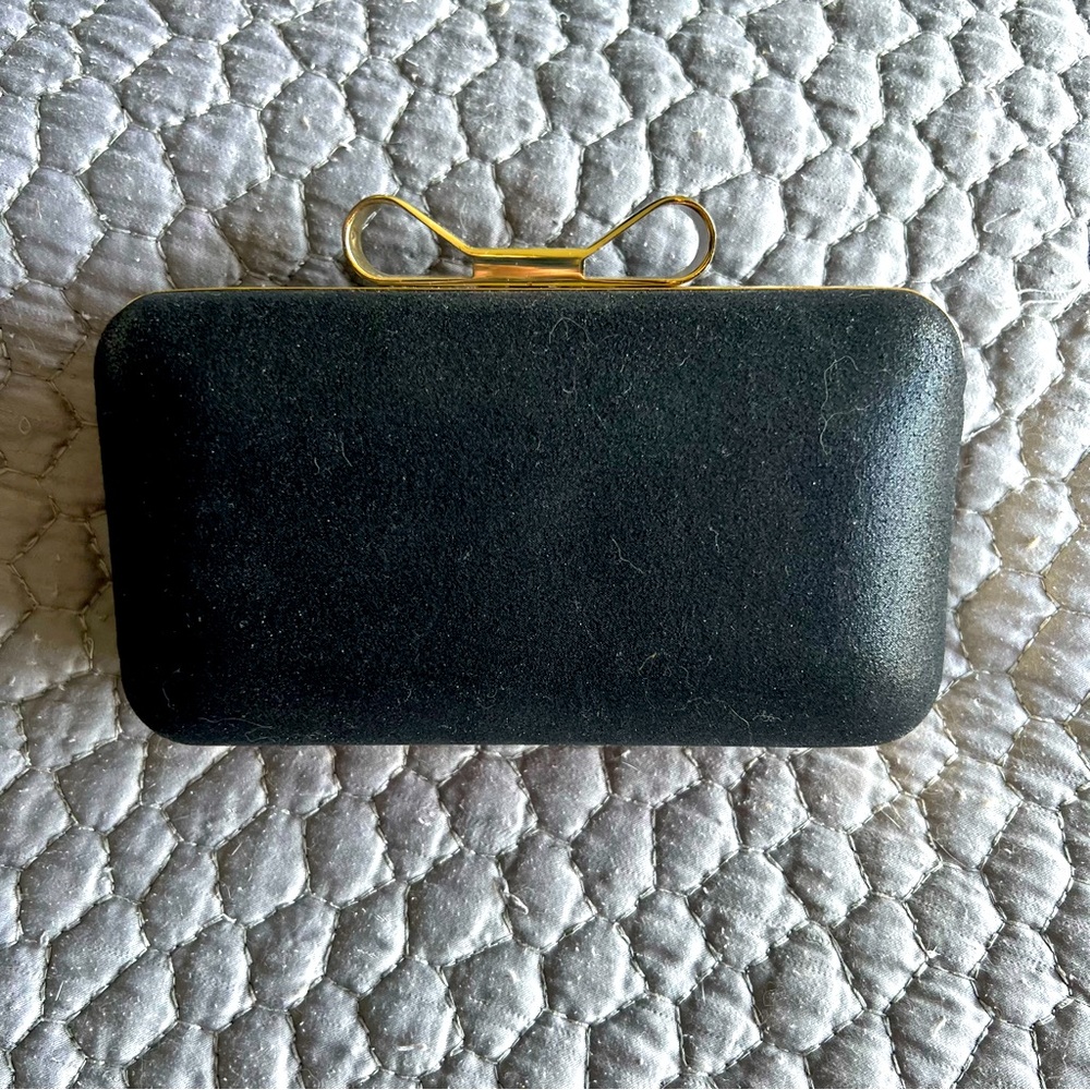 Black clutch with gold metal bow clasp